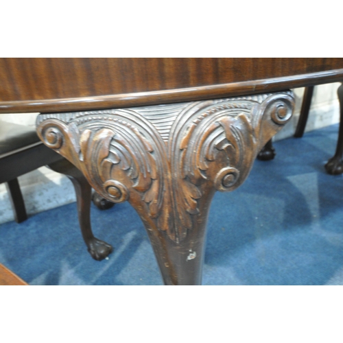 1307 - AN EARLY 2OTH CENTURY MAHOGANY OVAL WIND OUT DINING TABLE, the legs with scrolled and foliate detail... 