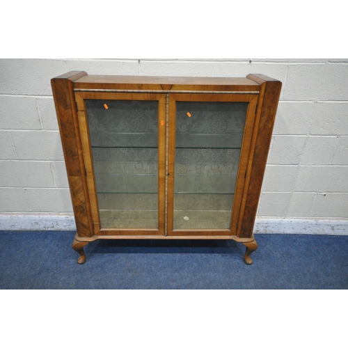 1312 - AN ART DECO WALNUT DISPLAY CABINET, the double glazed doors with geometric etched glass, enclosing t... 