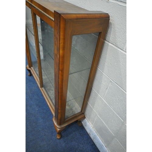 1312 - AN ART DECO WALNUT DISPLAY CABINET, the double glazed doors with geometric etched glass, enclosing t... 