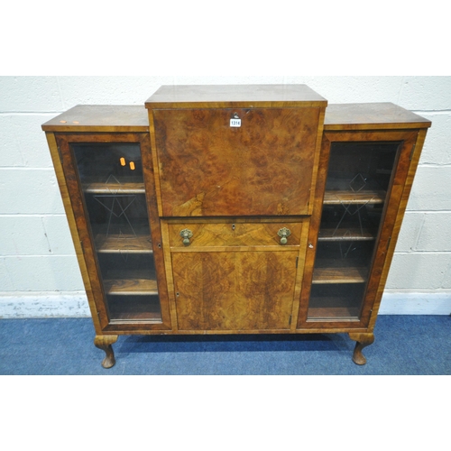 1314 - AN ART DECO WALNUT COCKTAIL CABINET, fitted with two glazed doors with geometric etching, flanking a... 