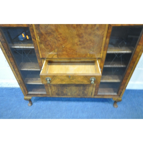 1314 - AN ART DECO WALNUT COCKTAIL CABINET, fitted with two glazed doors with geometric etching, flanking a... 