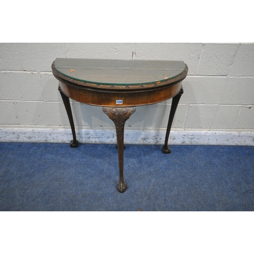 1318 - A 20TH CENTURY MAHOGANY DEMI-LUNE FOLD OVER GAMES TABLE, with a glass top protector, enclosing a gre... 