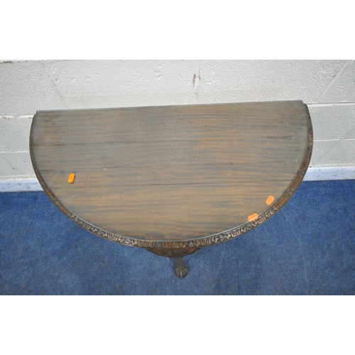 1318 - A 20TH CENTURY MAHOGANY DEMI-LUNE FOLD OVER GAMES TABLE, with a glass top protector, enclosing a gre... 