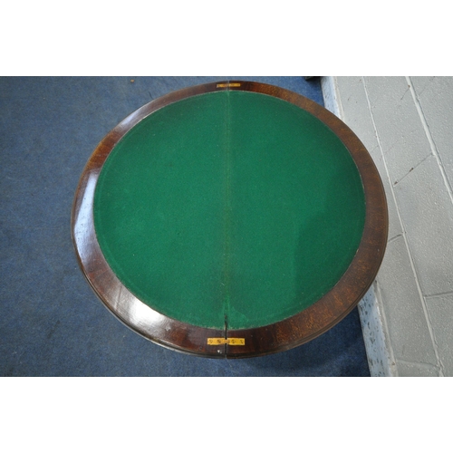 1318 - A 20TH CENTURY MAHOGANY DEMI-LUNE FOLD OVER GAMES TABLE, with a glass top protector, enclosing a gre... 