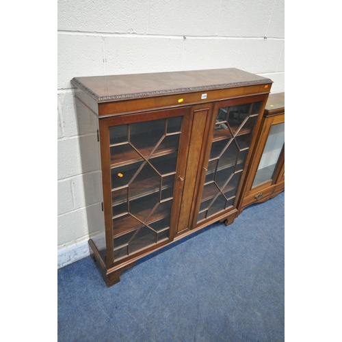 1320 - A 20TH CENTURY MAHOGANY BOOKCASE, the double glazed doors enclosing three adjustable shelves, width ... 