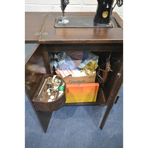 1323 - AN EARLY 20TH CENTURY OAK CASED SINGER TREADLE SEWING MACHINE, a gypsy wall mirror, an oval bevelled... 