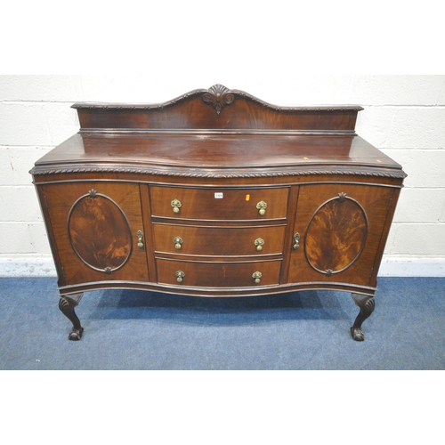 1324 - A 20TH CENTURY MAHOGANY SERPENTINE SIDEBOARD, with a raised back, fitted with double cupboard doors,... 