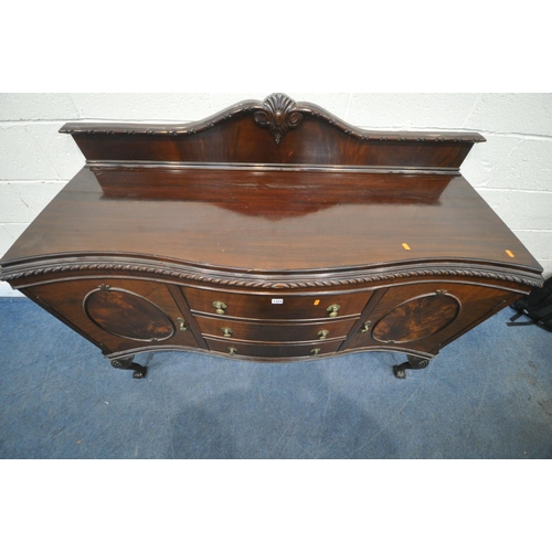 1324 - A 20TH CENTURY MAHOGANY SERPENTINE SIDEBOARD, with a raised back, fitted with double cupboard doors,... 