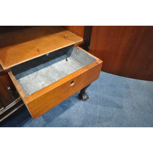 1324 - A 20TH CENTURY MAHOGANY SERPENTINE SIDEBOARD, with a raised back, fitted with double cupboard doors,... 