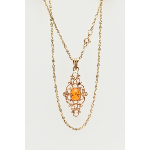 18 - A 9CT GOLD PENDANT AND CHAIN, of an openwork scrolling design with a central oval imitation amber ca... 