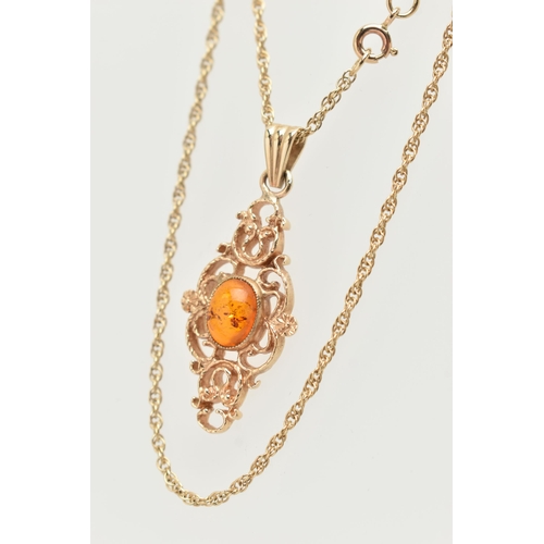 18 - A 9CT GOLD PENDANT AND CHAIN, of an openwork scrolling design with a central oval imitation amber ca... 