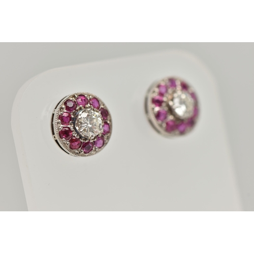 2 - A PAIR OF DIAMOND AND RUBY EARRINGS, designed as a round brilliant cut diamond, set with a surround ... 