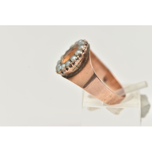 23 - A ROSE METAL CLUSTER RING, centering on an oval cut orange topaz within a surround of split pearls, ... 