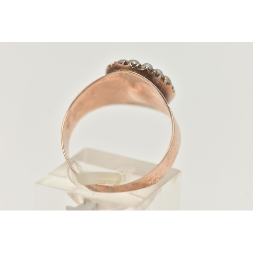 23 - A ROSE METAL CLUSTER RING, centering on an oval cut orange topaz within a surround of split pearls, ... 