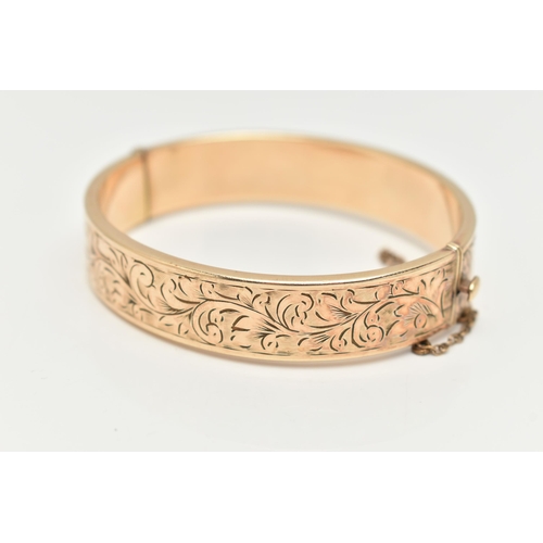 25 - A 9CT ROLLED GOLD HINGED BANGLE, floral detailed bangle, fitted with a push piece clasp with additio... 