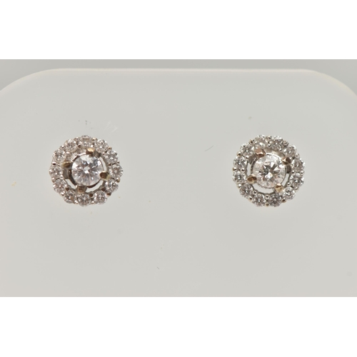 29 - A PAIR OF 9CT WHITE GOLD DIAMOND CLUSTER STUD EARRINGS, centering on a round brilliant cut diamond, ... 