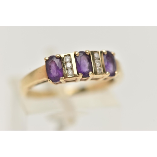 30 - A 9CT GOLD AMETHYST AND DIAMOND HALF ETERNITY RING, set with three oval cut amethysts, each claw set... 