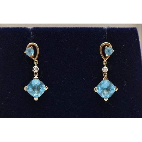 32 - A PAIR OF YELLOW METAL TOPAZ AND DIAMOND DROP EARRINGS, each pendant set with a square cut topaz, si... 