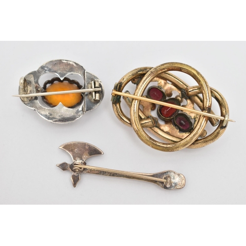 34 - THREE BROOCHES, to include a white metal Scottish hardstone set brooch, with an oval cut orange past... 