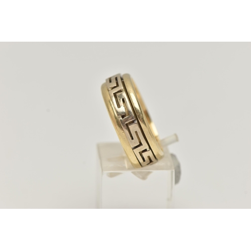 47 - A BI COLOUR GREEK RING, a yellow metal ring, fitted with a central spinning Greek key pattern, appro... 