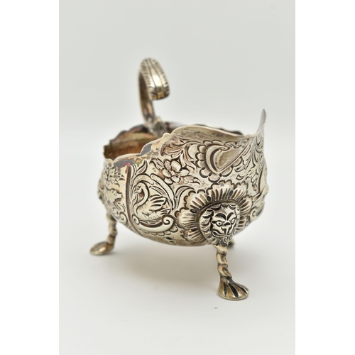 100 - AN IRISH SILVER GRAVY BOAT, early 20th century, embossed animal and floral pattern, with three lion ... 