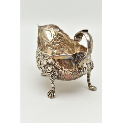 100 - AN IRISH SILVER GRAVY BOAT, early 20th century, embossed animal and floral pattern, with three lion ... 