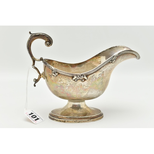 101 - A GEORGE V SILVER GRAVY BOAT, polished form, textured rim with floral detail, on an oval base with s... 