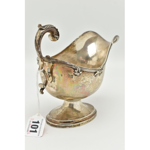 101 - A GEORGE V SILVER GRAVY BOAT, polished form, textured rim with floral detail, on an oval base with s... 