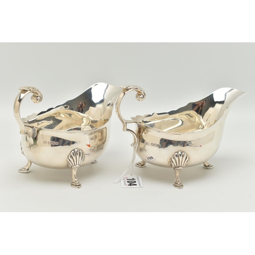 104 - A PAIR OF GEORGE V SAUCE BOATS, typical form silver sauce boats, scalloped rim, scrolled handle with... 