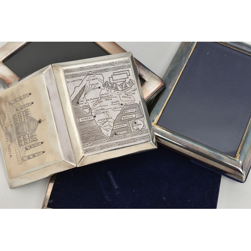 113 - A WHITE METAL CIGARETTE CASE AND PHOTO FRAMES, the cigarette case engraved depicting the Taj Mahal I... 