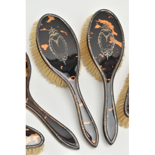 116 - A BOXED SILVER AND FAUX TORTOISESHELL DRESSING TABLE SET, comprising of two hair brushes, two clothe... 