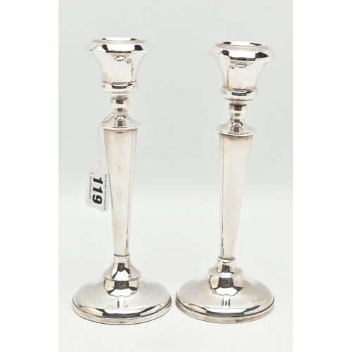 119 - A PAIR OF EARLY 20TH CENTURY CANDLESTICKS, tapering stems, on round weighted bases, hallmarked 'A J ... 