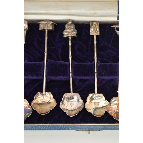 124 - A CASED SET OF CONTINETAL WHITE METAL TEASPOONS, a set of twelve teaspoons, with flower shape bowls,... 