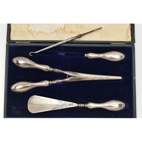 126 - A CASED SILVER HANDLED SHOE HORN, BUTTON HOOK AND GLOVE STRETCHER SET, polished silver handles with ... 