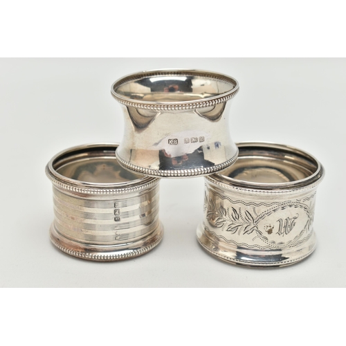 90 - THREE SILVER NAPKIN RINGS, all of different design, all with beaded edge detail, hallmarks for Birmi... 