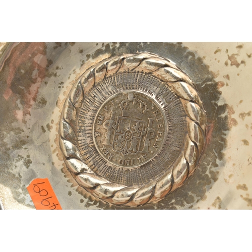 97 - A PERUVIAN WHITE METAL DISH MOUNTED WITH A SPANISH COIN, round dish, stamped to the reverse 'Kohler ... 