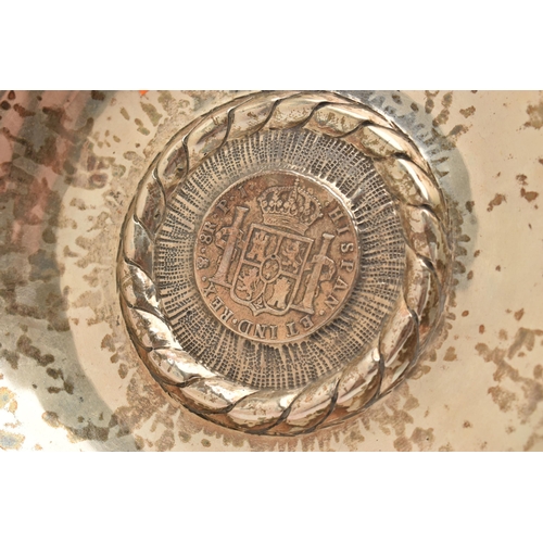 98 - A PERUVIAN WHITE METAL DISH MOUNTED WITH A SPANISH COIN, round dish, stamped to the reverse 'Kohler ... 