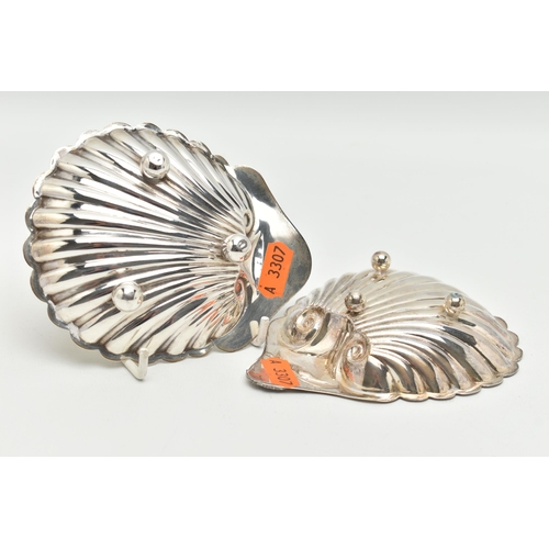 171 - TWO SILVER NUT DISHES, the first an Edward VII shell form nut dish, riased on three sperical feet, h... 