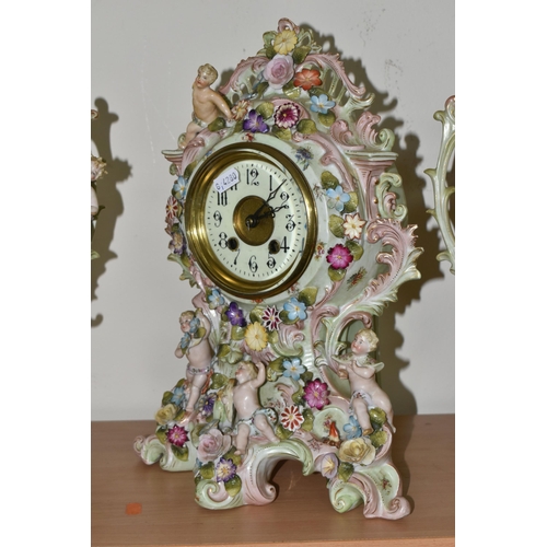 327 - A GERMAN PORCELAIN CLOCK GARNITURE SET,  porcelain clock garniture, late 19th century, the cartouche... 