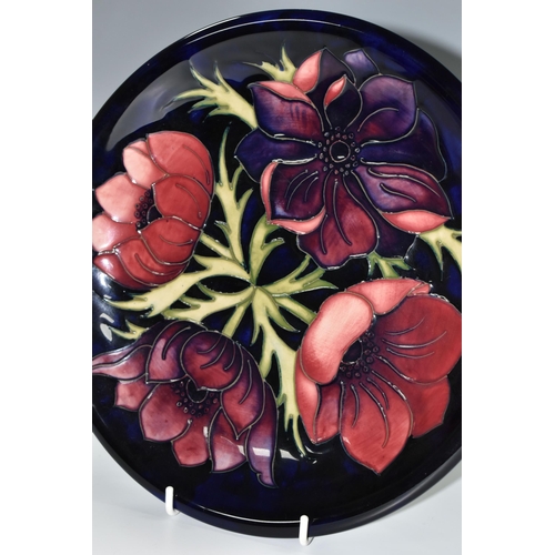 328 - A MOORCROFT POTTERY 'ANEMONE' DESIGN CABINET PLATE, purple and mauve Anemone on a dark blue ground, ... 