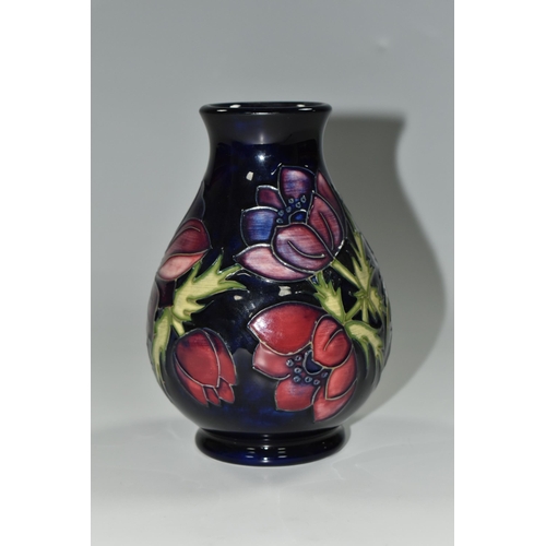 329 - A MOORCROFT POTTERY 'ANEMONE' PATTERN VASE,  of baluster form, purple and mauve flowers on a dark bl... 