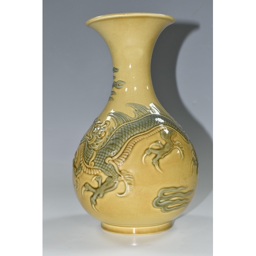 336 - A LLADRO RELIEF MOULDED DRAGON VASE, the mustard ground decorated with a four clawed dragon, printed... 