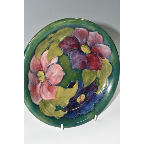 351 - A MOORCROFT POTTERY 'CLEMATIS' DESIGN CABINET PLATE, purple and mauve flowers on a green ground, imp... 