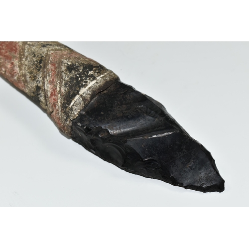 380 - TRIBAL INTEREST: AN OBSIDIAN KNIFE ON A PAINTED WOODEN SHAFT, the wooden shaft carved with geometric... 