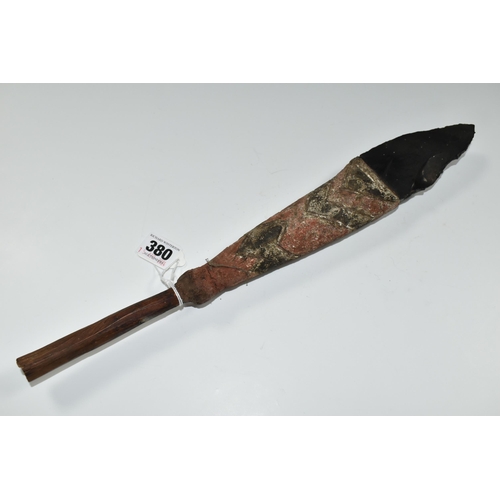 380 - TRIBAL INTEREST: AN OBSIDIAN KNIFE ON A PAINTED WOODEN SHAFT, the wooden shaft carved with geometric... 