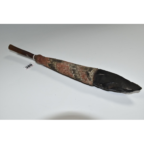 380 - TRIBAL INTEREST: AN OBSIDIAN KNIFE ON A PAINTED WOODEN SHAFT, the wooden shaft carved with geometric... 