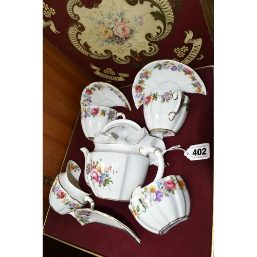 402 - A BOXED ROYAL CROWN DERBY TEA FOR TWO SET, with Derby posies teapot and the cups, saucers, milk, sug... 