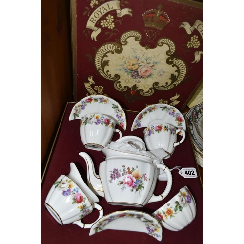 402 - A BOXED ROYAL CROWN DERBY TEA FOR TWO SET, with Derby posies teapot and the cups, saucers, milk, sug... 