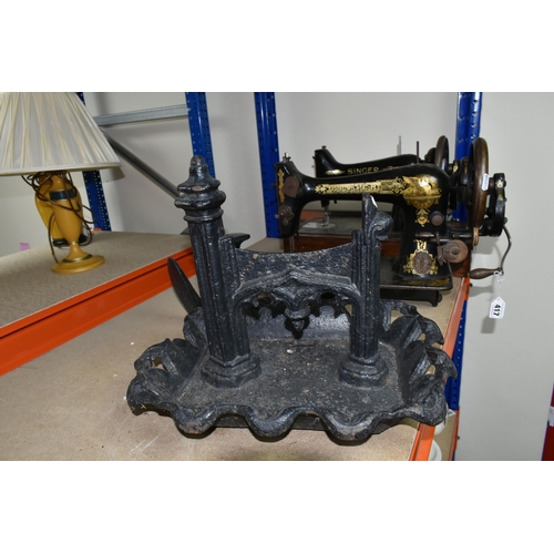 417 - A LARGE ORNATE CAST IRON BOOT SCRAPER AND TWO SINGER SEWING MACHINES, comprising a Victorian cast ir... 