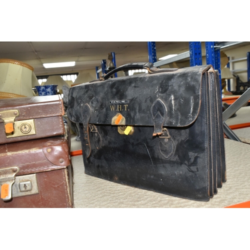 517 - A GROUP OF SUITCASES AND BRIEFCASES, to include a small brown vintage suitcase, width 50cm x height ... 